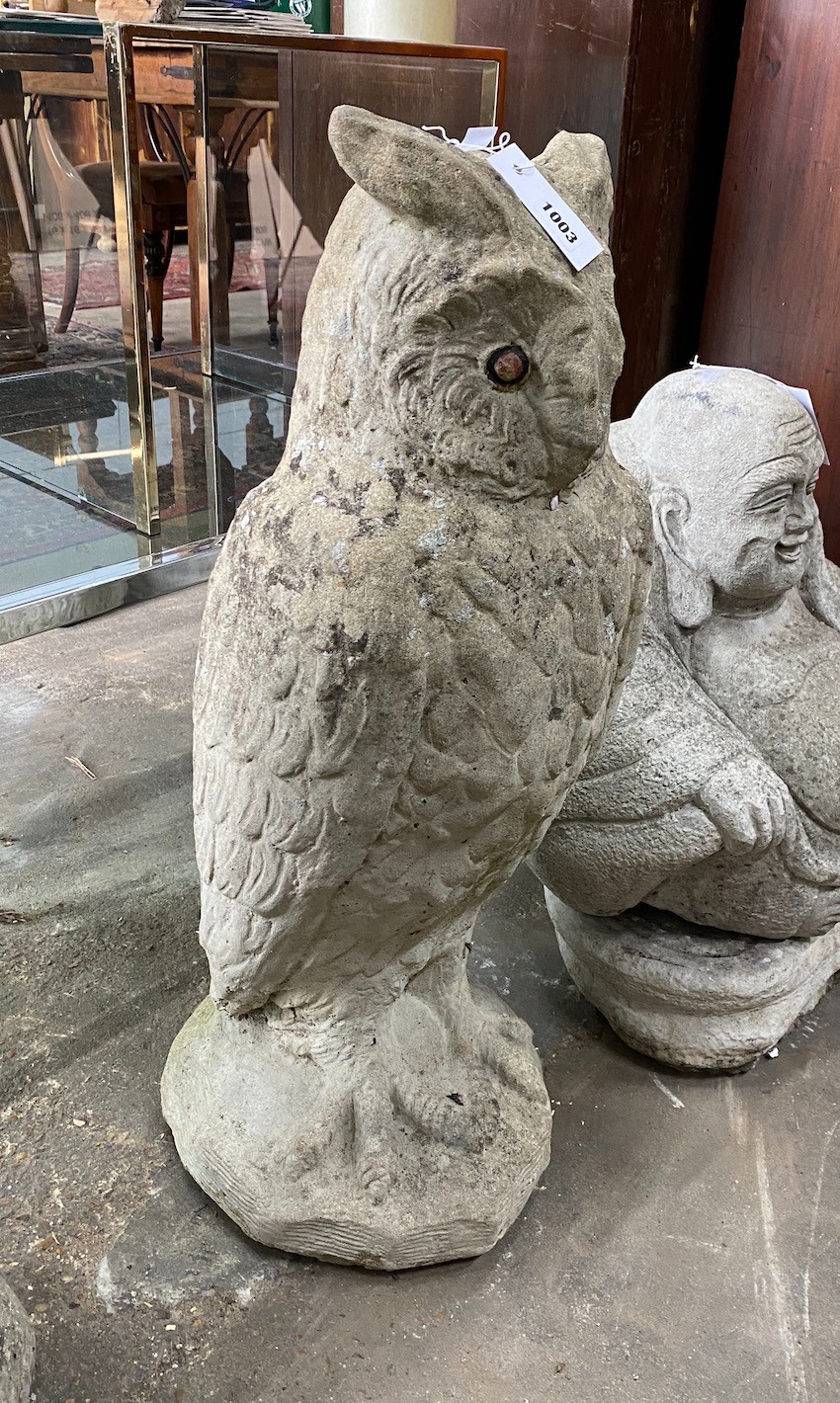 A reconstituted stone garden ornament modelled as a standing owl, height 71cm